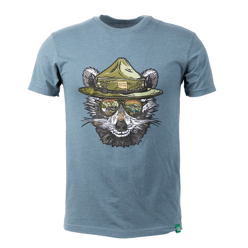 Blue t-shirt with a raccoon graphic wearing a hat and sunglasses on a white background