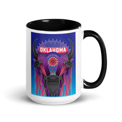 Ceramic mug with black handle and a vibrant illustrated bison decorated with an Indian Blanket wildflower and downtown Oklahoma City. Line one text reads 