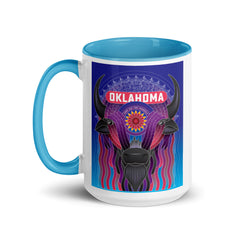 Ceramic mug with black handle and a vibrant illustrated bison decorated with an Indian Blanket wildflower and downtown Oklahoma City. Line one text reads 