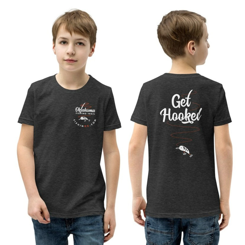 Oklahoma Fishing Trail Double Sided Youth Boys T-Shirt in Black. Oklahoma Fishing Trail left chest print on the front, and "Get Hooked" fish design on the back.